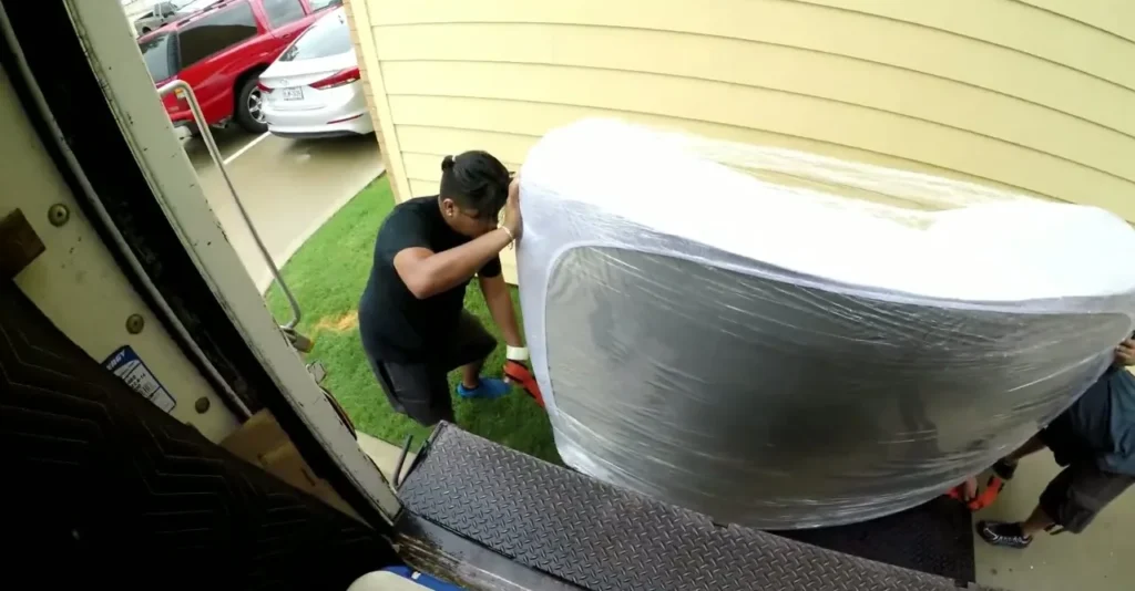 Paramount 16 Wrapped mattress going up the truck ramp outside an apartment